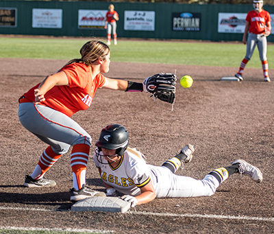 girl on ground touching base ahead of tag