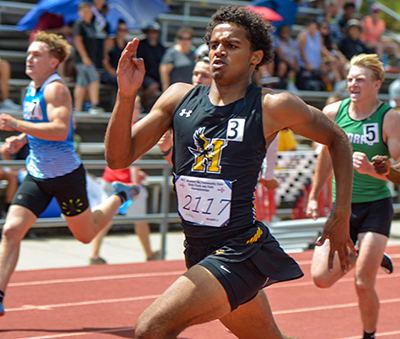 boy in mid stride on track sprint