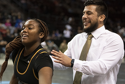 smling girl wrestler and smling coach