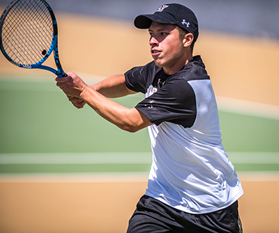 boy player returning a serve