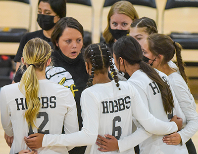 coach in the center of player huddle