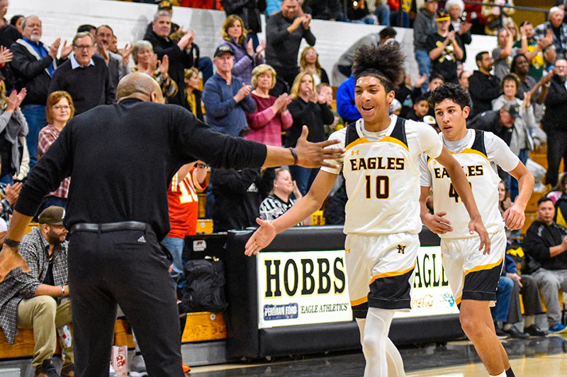 student shaking hands with coach