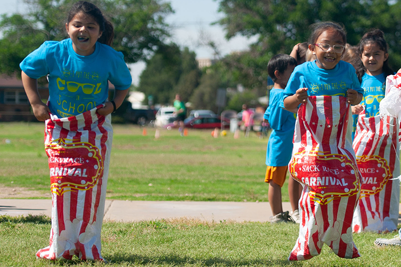 two girls hopping in potato sacks