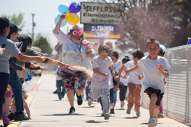 kids running on sidewalk in chalk cloud