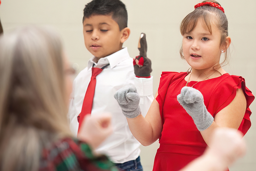 girl singing for teacher