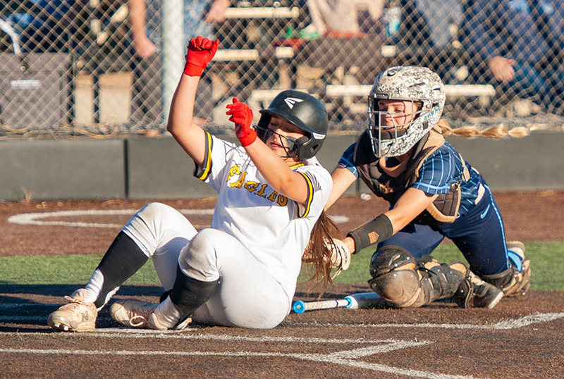 girl sliding into home while being tagged