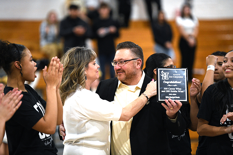 coach receiving award from Athletic Director