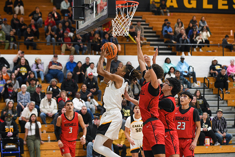 hobbs player with three roswell defenders at goal