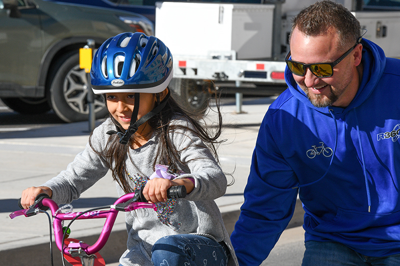 girl being pushed on bike