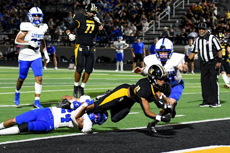 player stretching across goal line to score