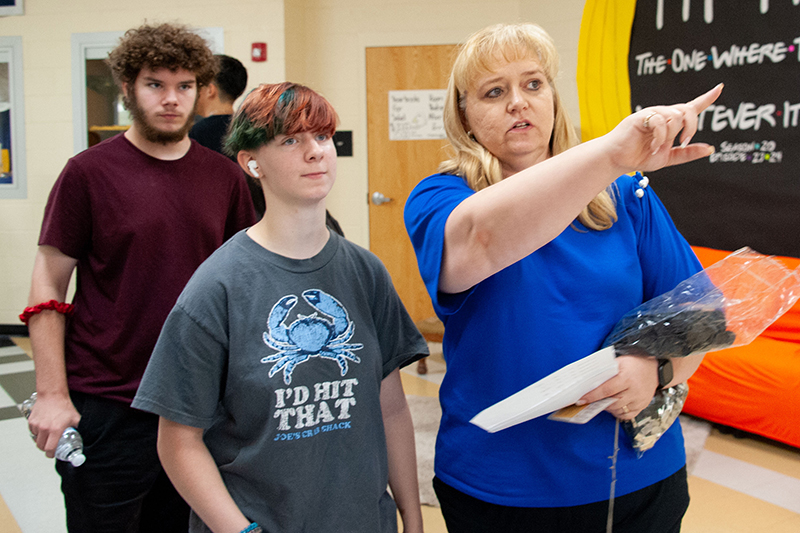 woman pointing direcdtions to student