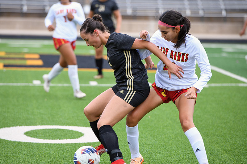 two players battle for the ball