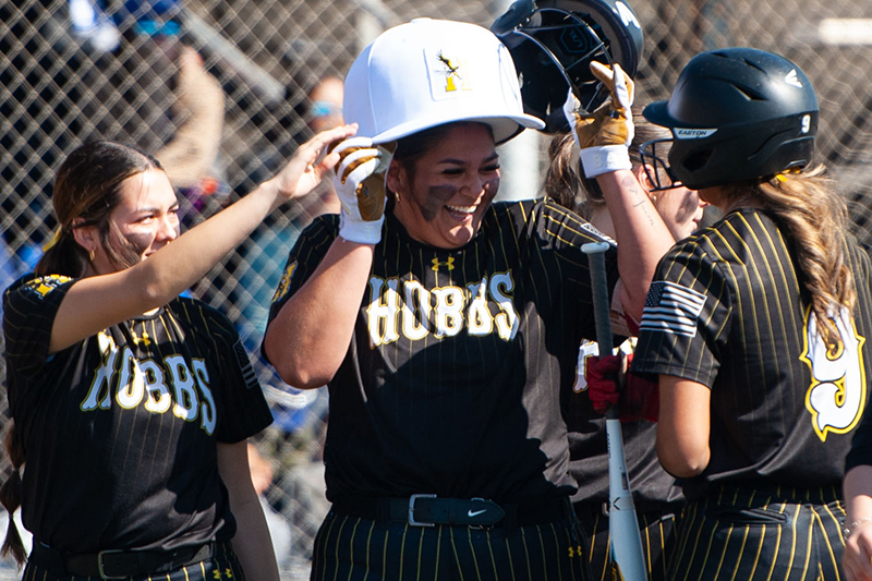 smiling girl surrounded by teammates