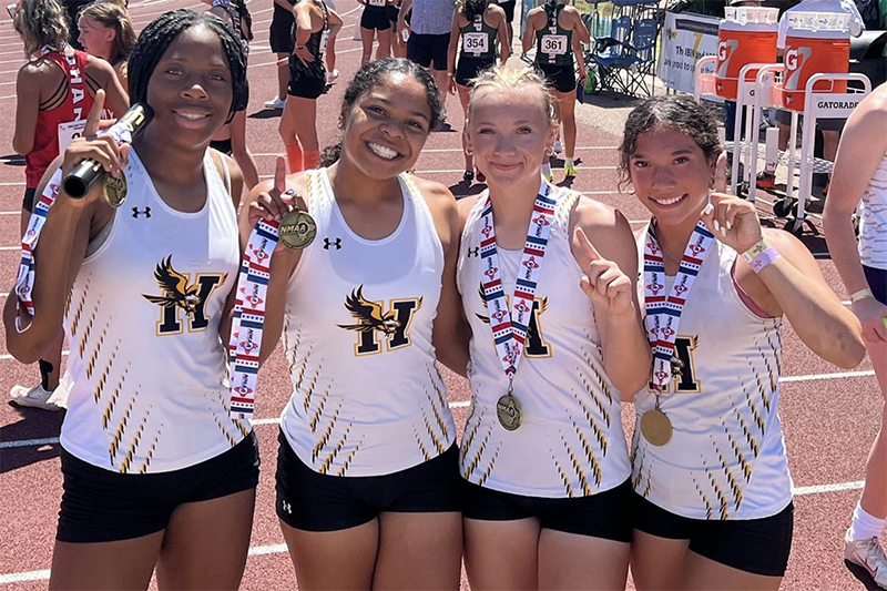 four girls holding medals