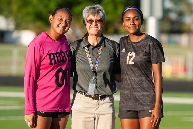 three smiling students