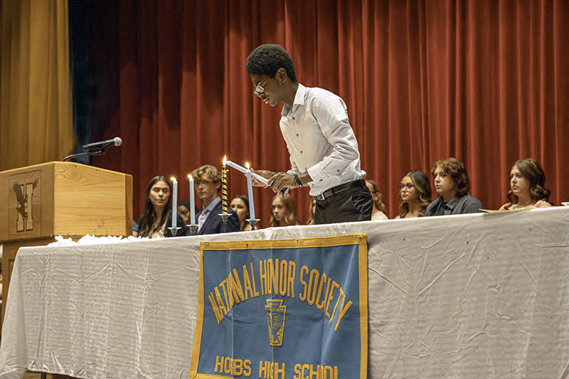 student lighting candle