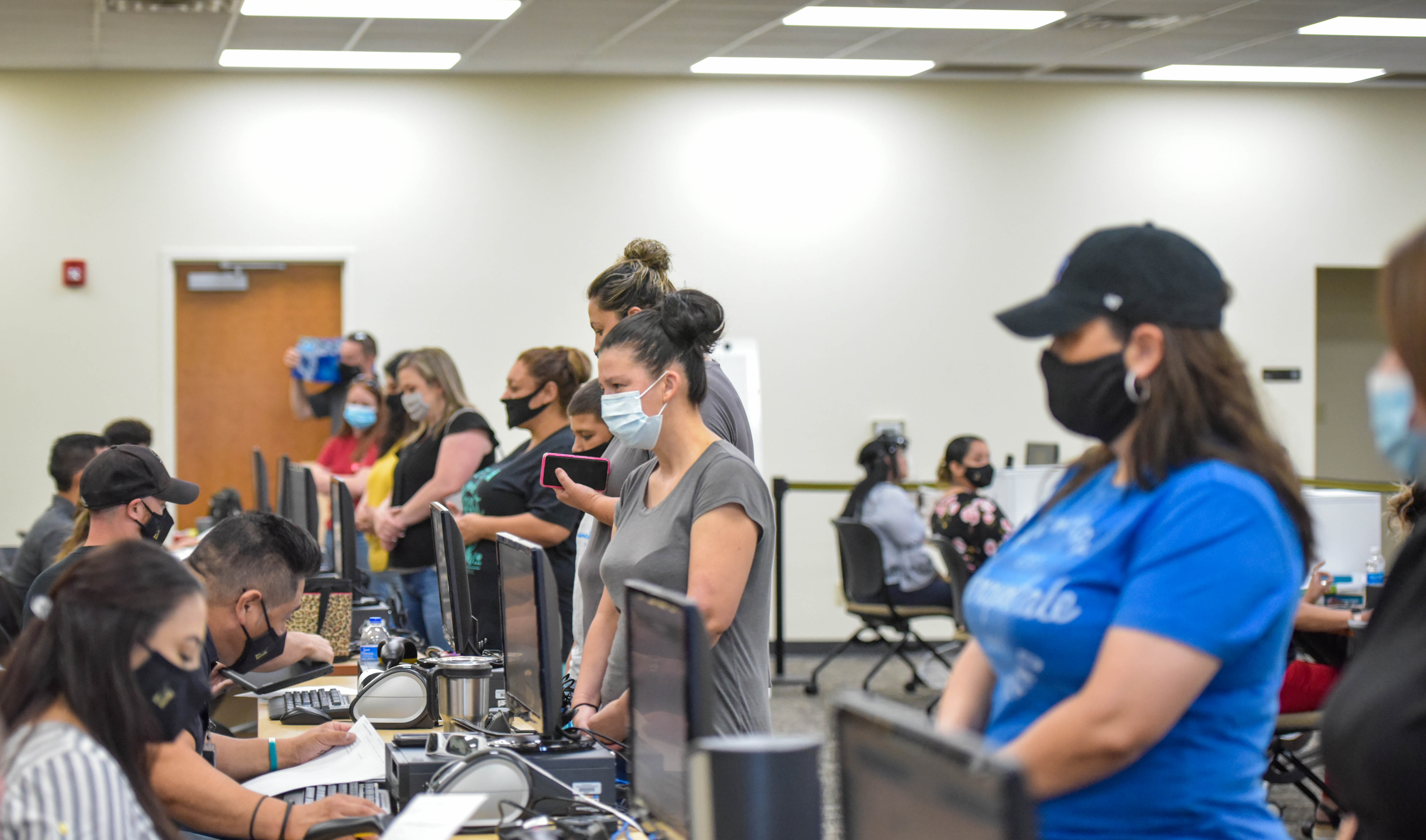 Parents wait in line to pick up laptop.