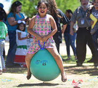 girl bouncing on ball