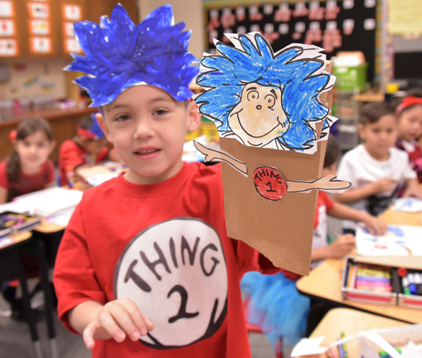 kid holding dr seuss puppet