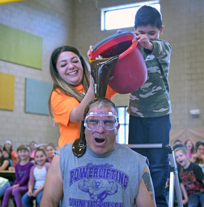 choc sauce being poured on teacher