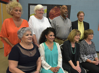 retirees sitting on chairs and standing