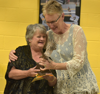 employee being hugged by school board member