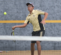 player hitting tennis ball